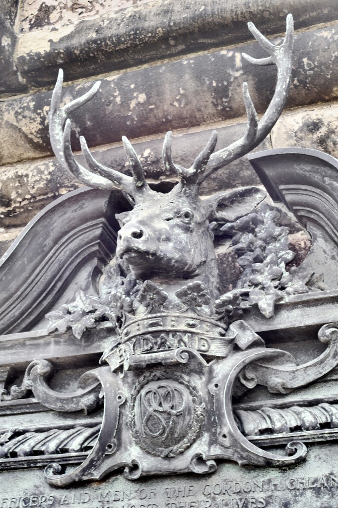 The top of a war memorial outside of Edinburgh Castle decorated with classic Highlands stag.