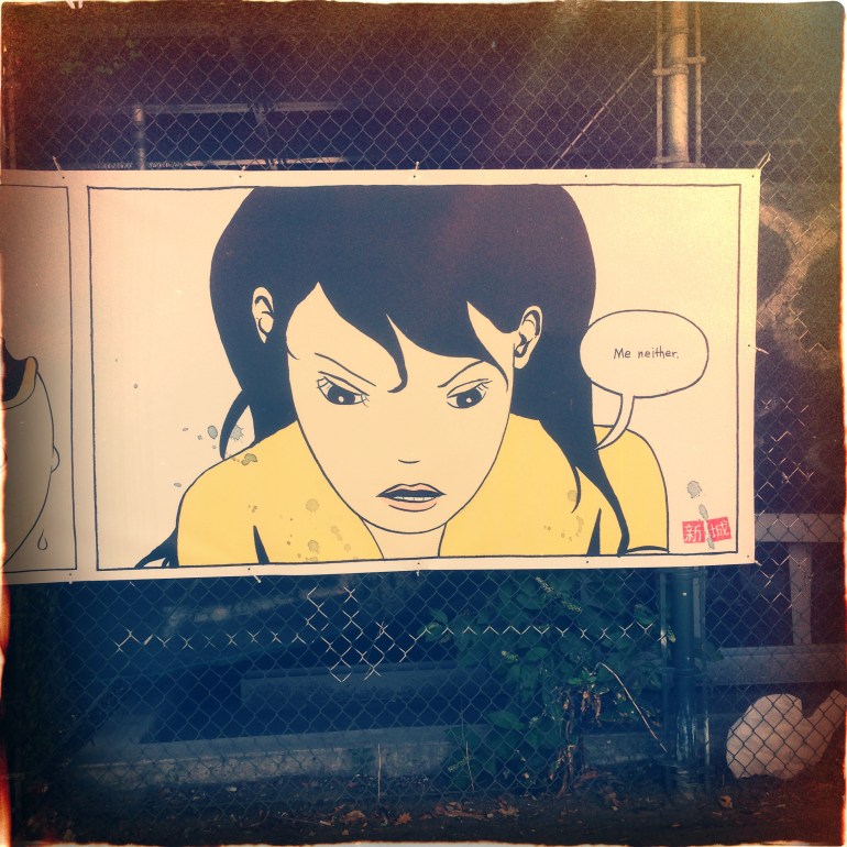 Ad? Massive art project? A mural featuring this chick and a guy catching a fish wrapped a vacant lot's fence under an overpass in Williamsburg