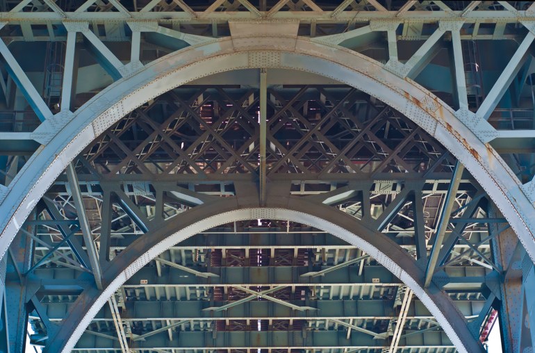 Arches, rust and paint under the Williamsburg Bridge. 